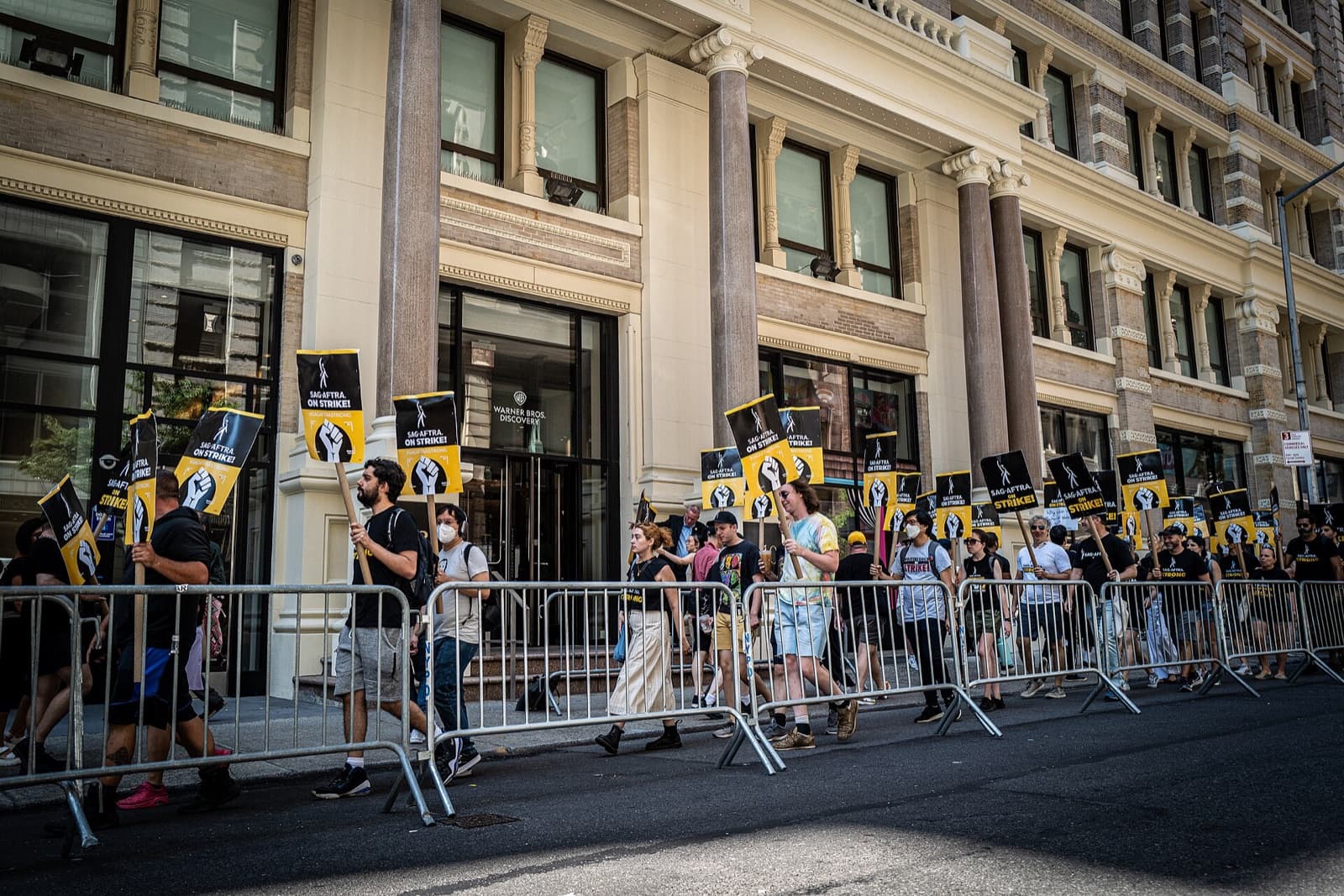 SAG-AFTRA members on a picket line during the 2023 strike, holding union signs
