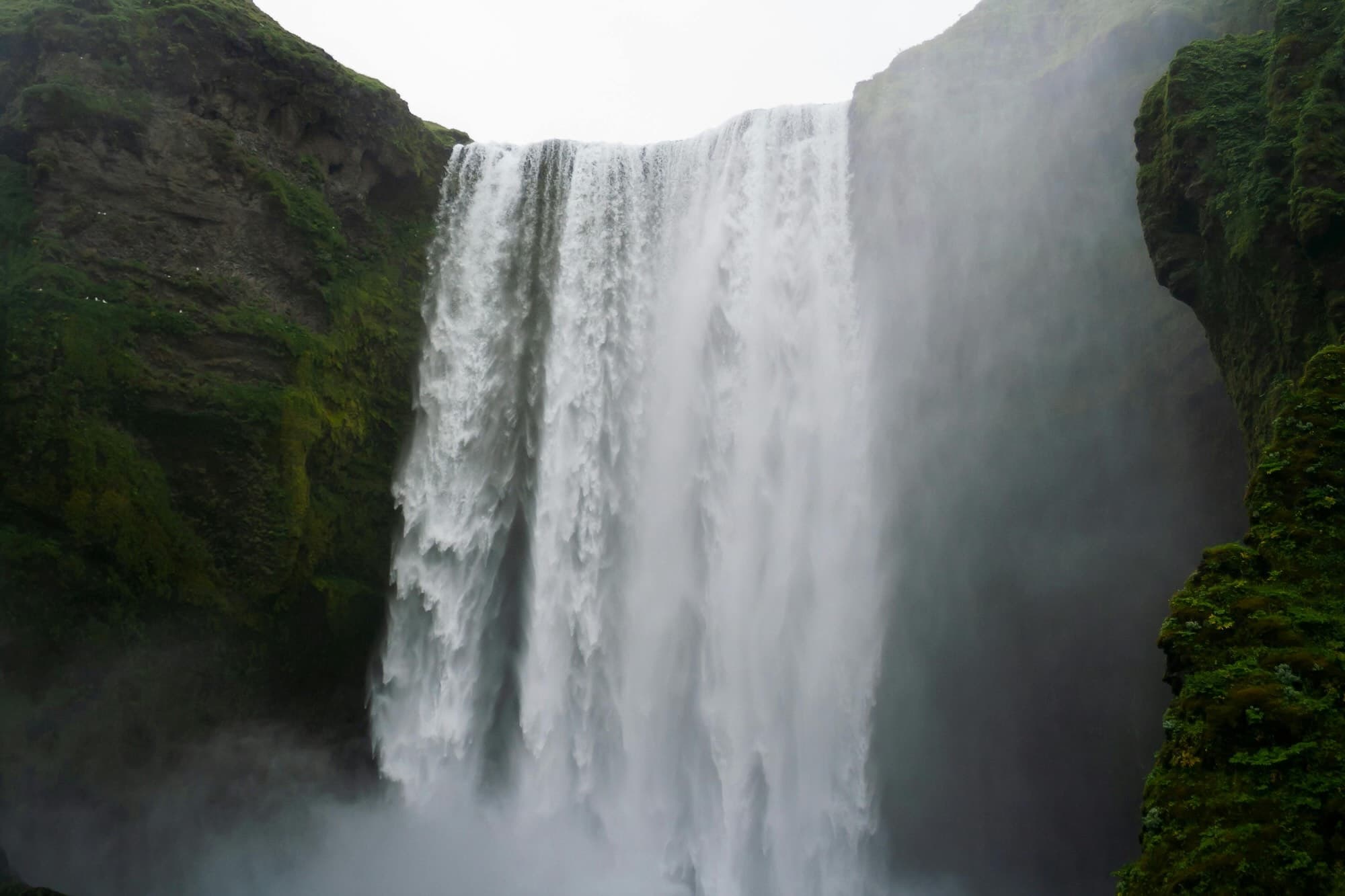 A powerful waterfall cascading down moss-covered cliffs, evoking the layered flow of revenue in a film recoupment waterfall